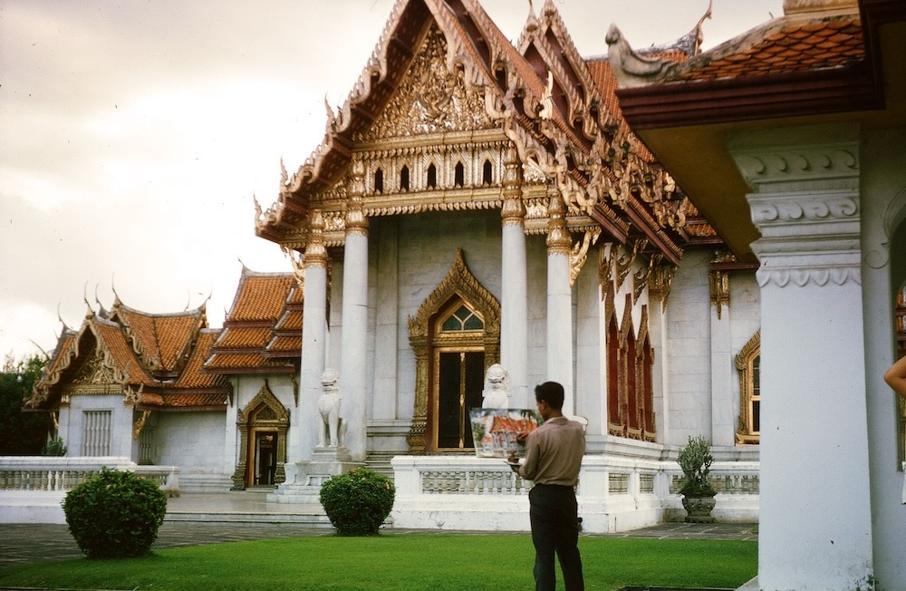 A local artist adding final touches to picture of the Marble Temple in Bangkok, Thailand